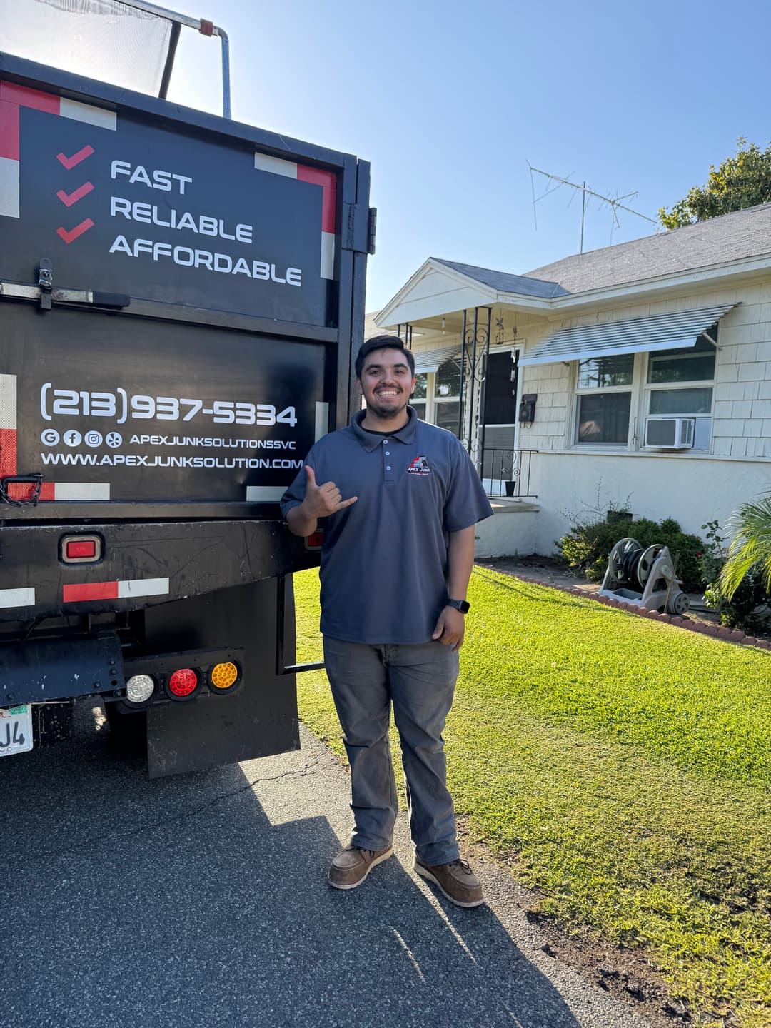 APEX Junk Solutions employee standing by truck, promoting fast, reliable, and affordable services.